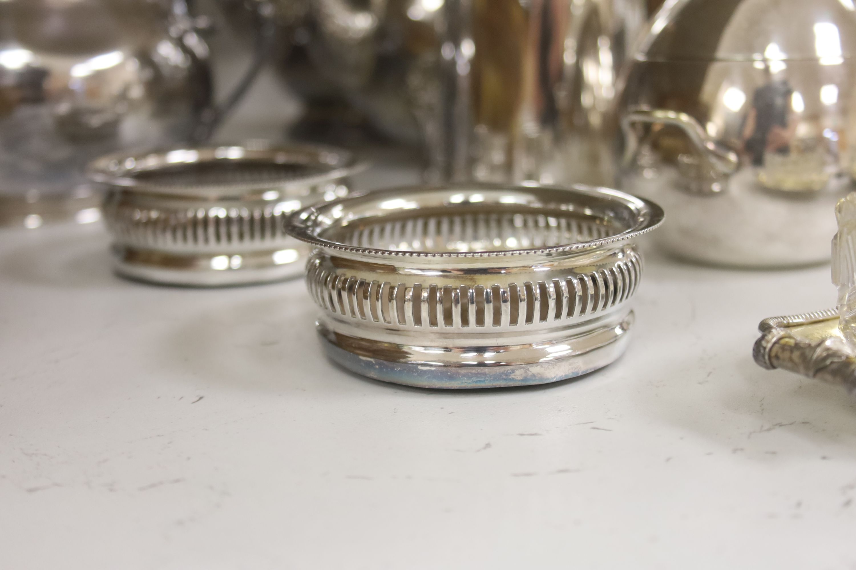 A group of assorted plated wares including a set of four gilt salts and a butter dish